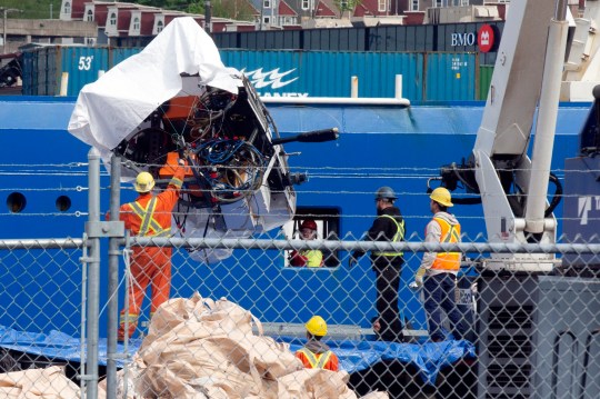 FILE - Debris from the Titan submersible, recovered from the ocean floor near the wreck of the Titanic, is unloaded from the ship Horizon Arctic at the Canadian Coast Guard pier in St. John's, Newfoundland, Wednesday, June 28, 2023. OceanGate, the company that owned a submersible that imploded on its way to explore the wreck of the Titanic, killing all five onboard, said Thursday, July 6, that it has suspended operations. (Paul Daly/The Canadian Press via AP, File) 13510649