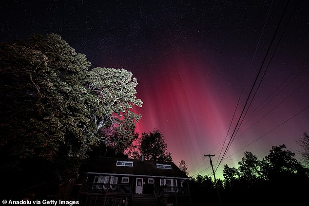 Although today's display is likely to be less intense than those seen over New York (pictured), experts predict that the Northern Lights should still be visible