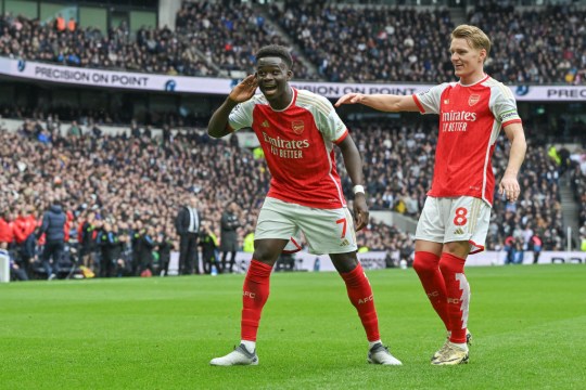 Bukayo Saka of Arsenal cs\with Martin Odegaard of Arsenal during the Premier League match between Tottenham Hotspur and Arsenal FC at Tottenham Hotspur Stadium