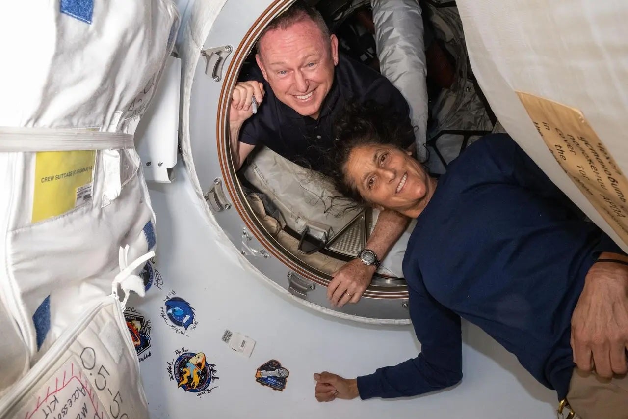 NASA’s Boeing Crew Flight Test astronauts Butch Wilmore and Suni Williams pose in June onboard the International Space Station’s Harmony module and Boeing’s Starliner spacecraft. The pair will return to Earth in February 2025.