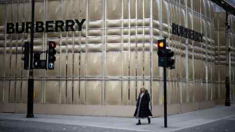 A person walks past a Burberry store in London