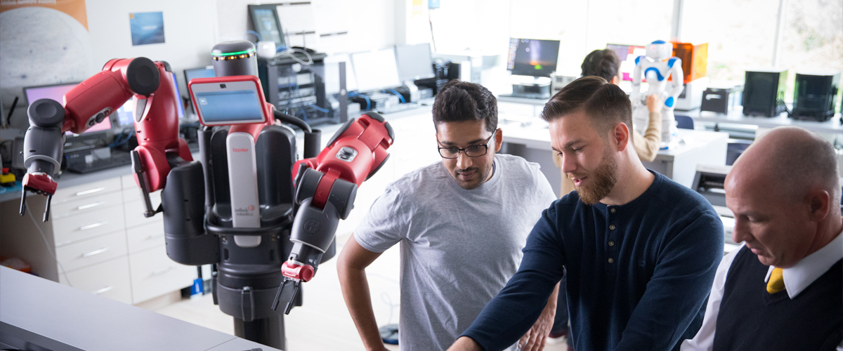 Two students work with a faculty member in the College of Engineering and Computing Sciences in the Entrepreneurship and Technology Innovation Center (ETIC).