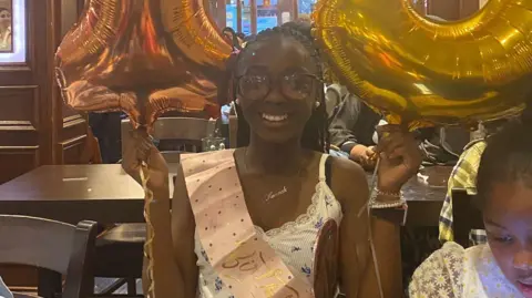 Jacobs family Hannah Jacobs with 13th birthday sash and balloons