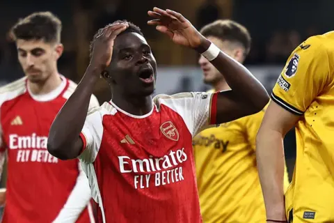 Getty Images Arsenal's English midfielder Bukayo Saka reacts after missing a chance during the English Premier League football match between Wolverhampton Wanderers and Arsenal