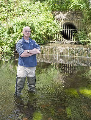 Shameful: Professor Jamie Woodward next to an outflow pipe on the River Tame