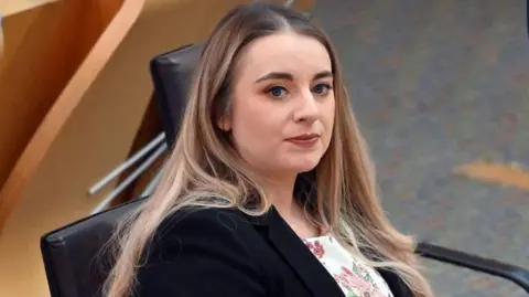 Getty Images Megan Gallacher sitting in the Scottish parliament