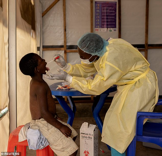 Christian Musema, a lab nurse, takes a sample from a child declared a suspected case Mpox