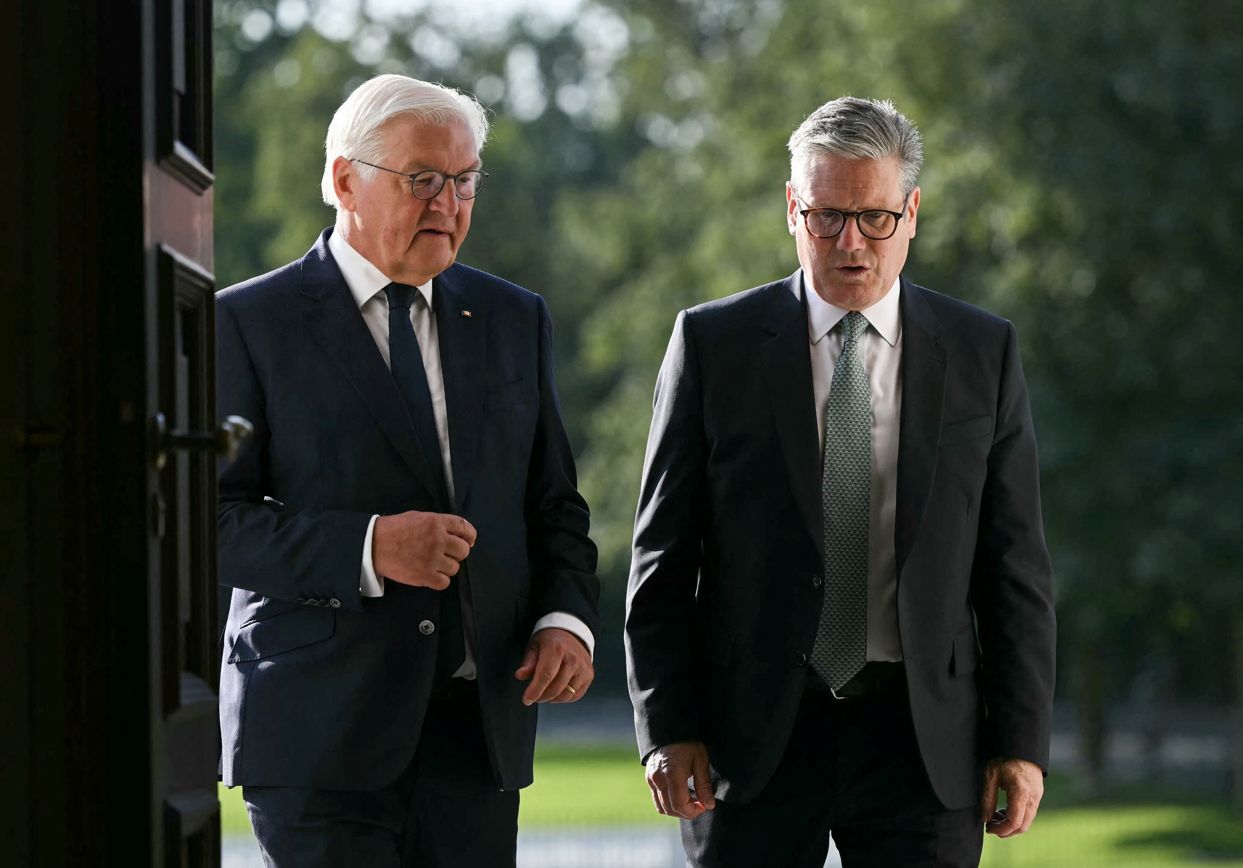 German President Frank-Walter Steinmeier leads Britain's Prime Minister Keir Starmer into Bellevue presidential Palace upon his arrival