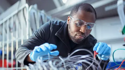 Getty Images Electrical engineer assembling components in electronics factory