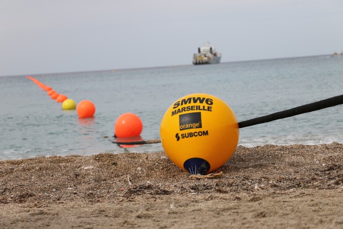 A line of buoys extend from the shore out to sea