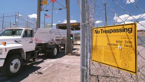 Getty Images A truck exits the Los Alamos national laboratory, in New Mexico. A sign in the foreground says: "No Trespassing."