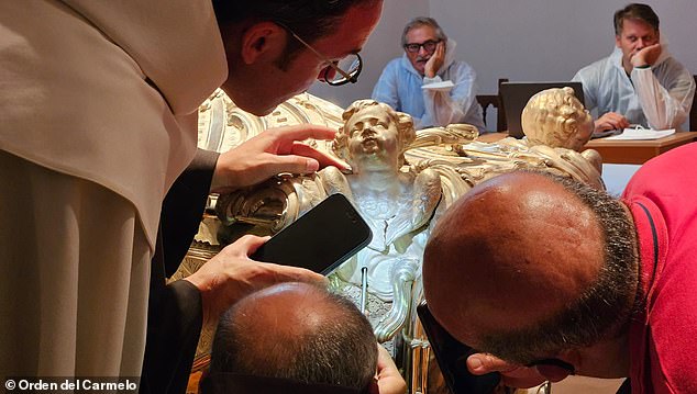 The team has not released pictures of Saint Teresa's remains and have only stated that she remains unchanged since her body was last exhumed in 1914. Pictured: The silver coffin encased in marble of Saint Teresa of Avila