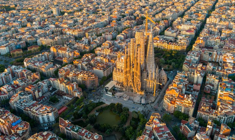 an aerial view of a city with a large building in the middle