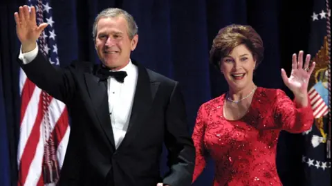 Getty Images G.W. Bush and Laura Bush at the Florida Inauguration Ball in Washington, United States on January 20, 2001. Mrs Bush wears a glittering red dress.