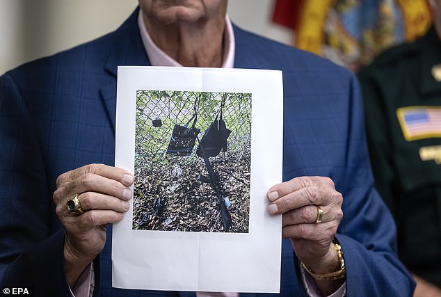 West Palm Beach Sheriff Sheriff Ric Bradshaw holds up an image of Routh's backpack, bag, GoPro and AK-47 style rile left outside Trump International Golf Club on Sunday when he fled the scene as the Secret Service opened fire