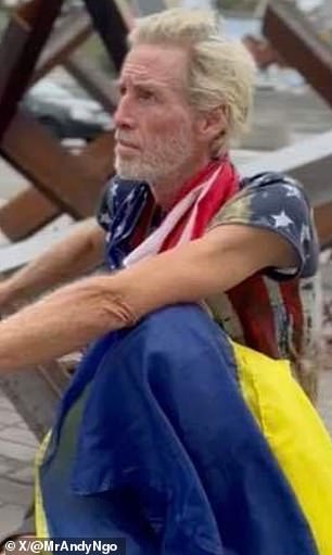 He is pictured above draped in the American and Ukrainian flags