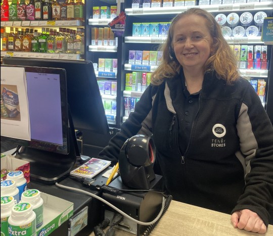 Fiona Malone behind the counter, wearing headsets