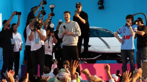 Don Arnold/WireImage MrBeast speaks to fans on a stage in Sydney