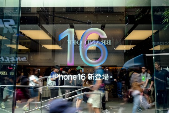 A logo for the iPhone 16 is seen on the outside of a shopping centre 