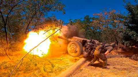 Russian soldier fires from D-30 howitzer towards Ukrainian positions in an undisclosed location in Ukraine.