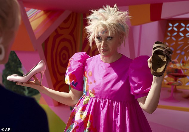 Please decide: In the Barbie movie, 'Stereotypical Barbie' is pressured by 'Weird Barbie' (played by Kate McKinnon, pictured) to choose the Birkenstock over a pink high-heel so she could 'know the truth about the universe'