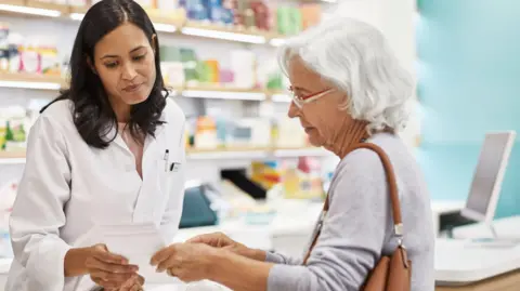 Getty Images Pharmacist offering advice