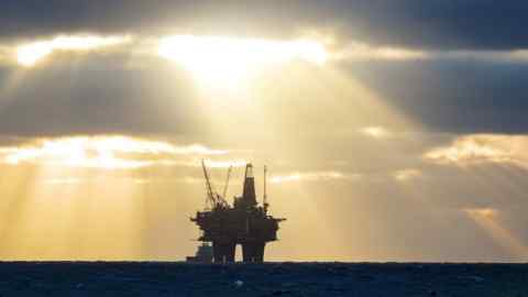 The sun breaks though cloud on to a north sea oil platform