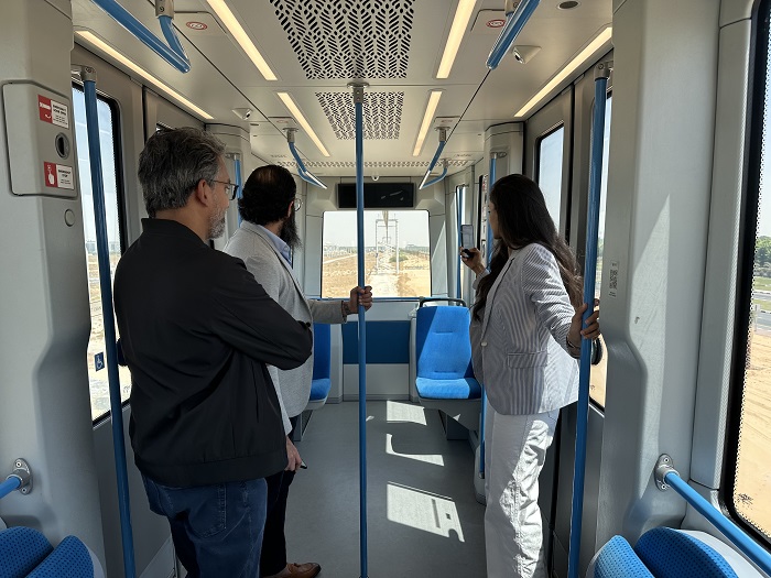 Asia Mobiliti delegation inside the Karat during the 2.5km test ride at the Sharjah Research, Technology, and Innovation Park. The pod has a passenger capacity of 25 to 30, designed for efficient urban transit.