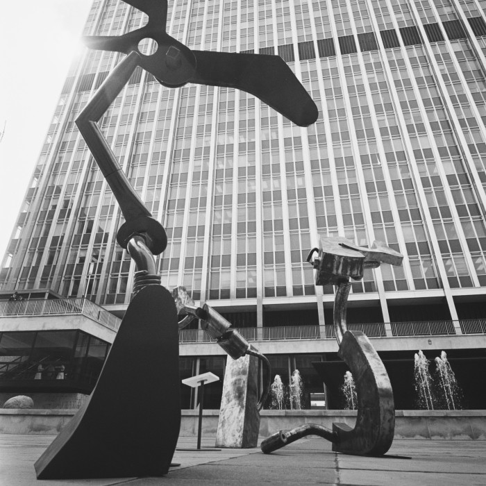 Black and white photo looking through a sculpture at Britannic House building, now called Citypoint