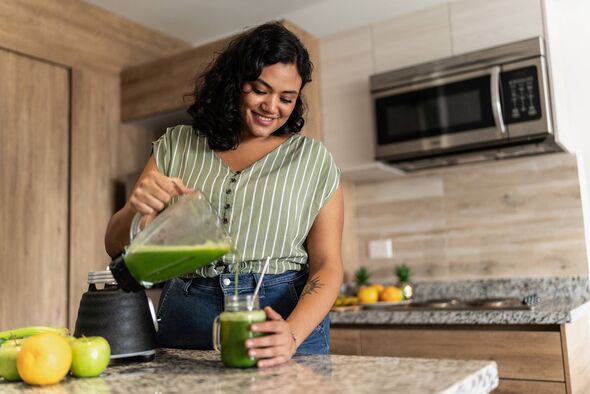 Young woman preparing detox juice 