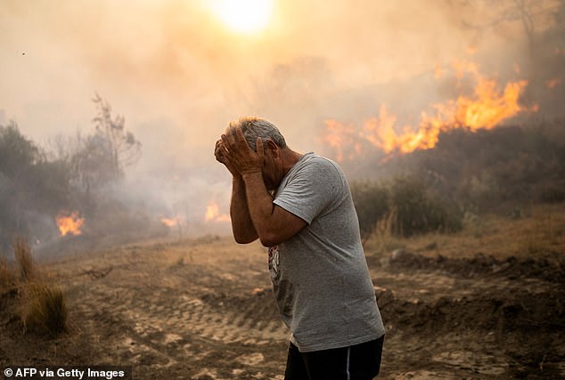 Last year was officially the hottest year since global records began in 1850. Pictured, a man recoils as a fire burns into the village of Gennadi on the Greek Aegean island of Rhodes, July 25, 2023