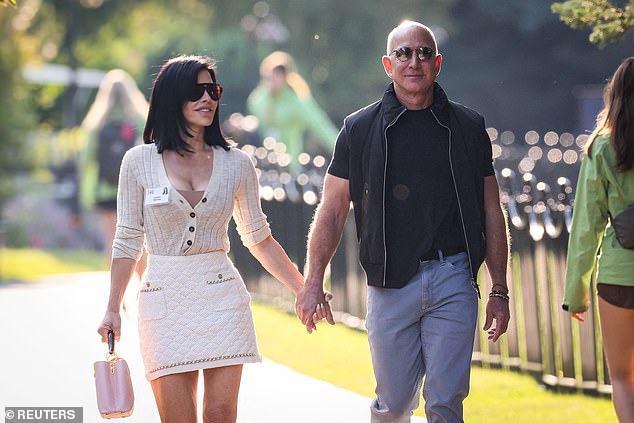 Above, Jeff Bezos and Lauren Sanchez, take a stroll at Sun Valley Resort in Idaho, July 10, 2024. Sanchez, Bezos's fiancée, confirmed her partner's commitment to keeping his morning hour of 'puttering time' free of 'screen time' in an interview with People just last month