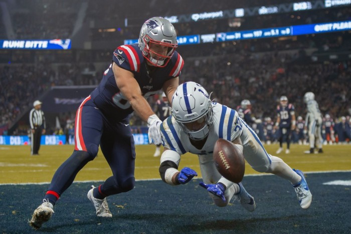 Hunter Henry of New England Patriots and Julian Blackmon of Indianapolis Colts battle for the ball during an NFL match at Deutsche Bank Park