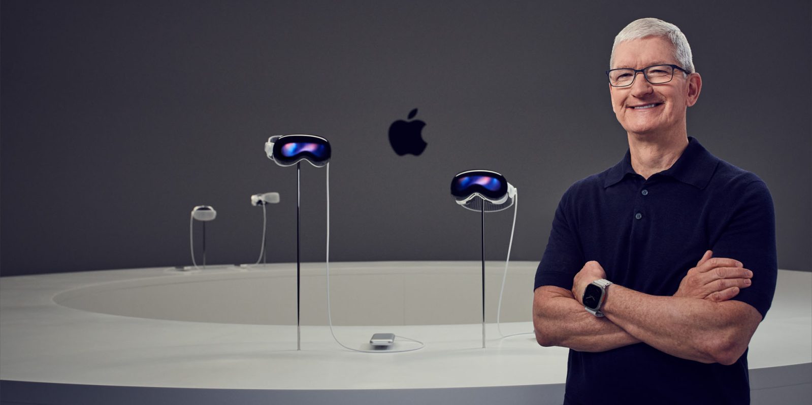 Cook defends Apple coming late to AI with four words | Cook posing with Vision Pro display