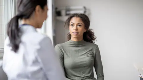 Getty Images Woman seeing a specialist