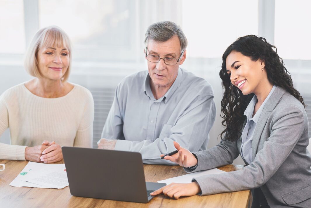 Elderly couple consulting with financial advisor