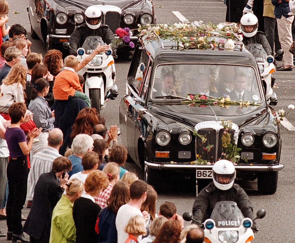 The M1 was closed to traffic - but not to the public - on Saturday 6 September 1997 to allow for the funeral procession of Diana, Princess of Wales to Althorp. A woman is pictured throwing flowers towards the hearse as crowds gather at junction 15 of the M1 motorway to pay their respects