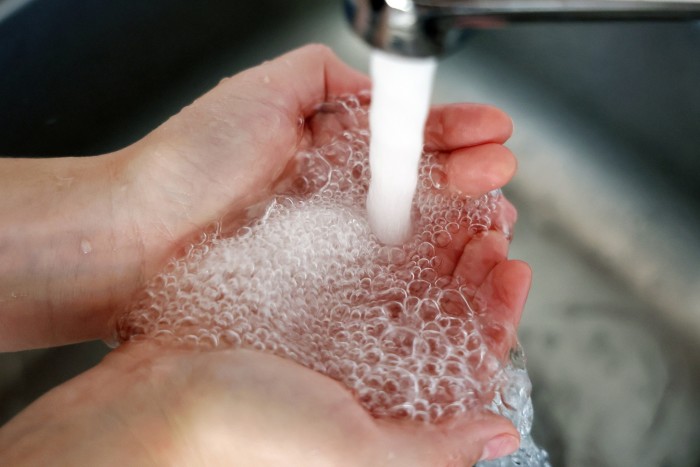 Water runs from a tap at a home in London