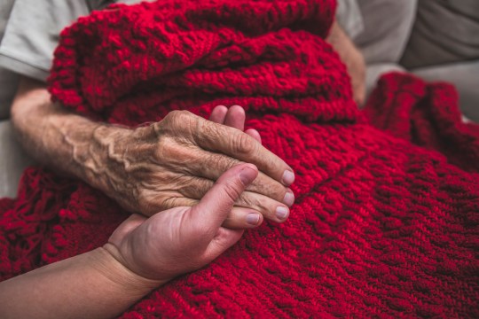 A stock photo of a Hospice Nurse visiting an Elderly male patient who is receiving hospice/palliative care.