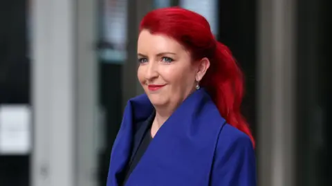 Reuters Louise Haigh, who has bright red hair and a blue coat on, seen outside BBC Broadcasting House