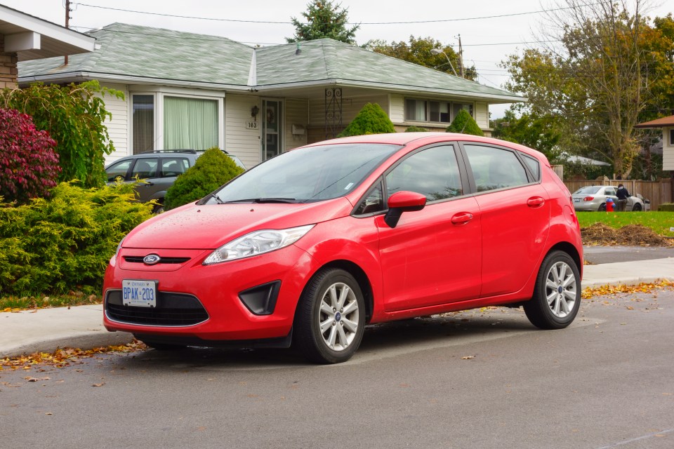 A Red coloured, sixth-generation Ford Fiesta compact car