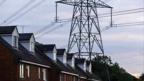 An electricity pylon beyond a row of residential houses near Stevenage