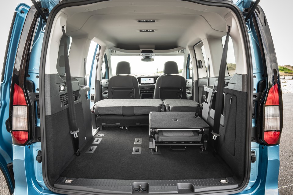 Cargo area of a minivan with rear seats folded down.