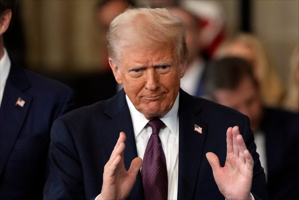 President Donald Trump gesturing during an inauguration.