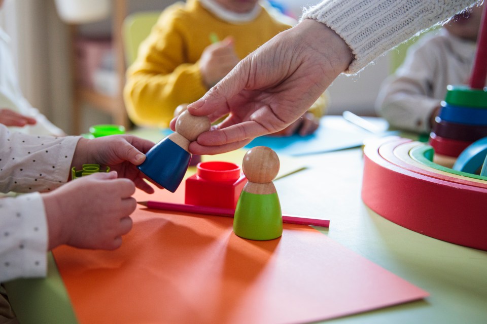 Preschool children playing with wooden toys.