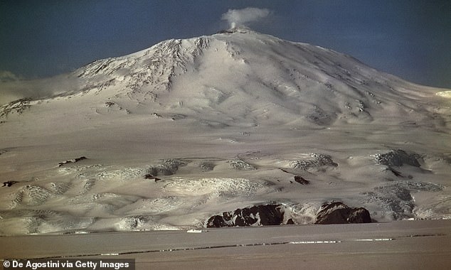 Experts have warned of a newly discovered a phenomenon in Antarctica that could increase volcanic activity and global sea level rise. Pictured is Mount Erebus, the continent's largest largest active volcano