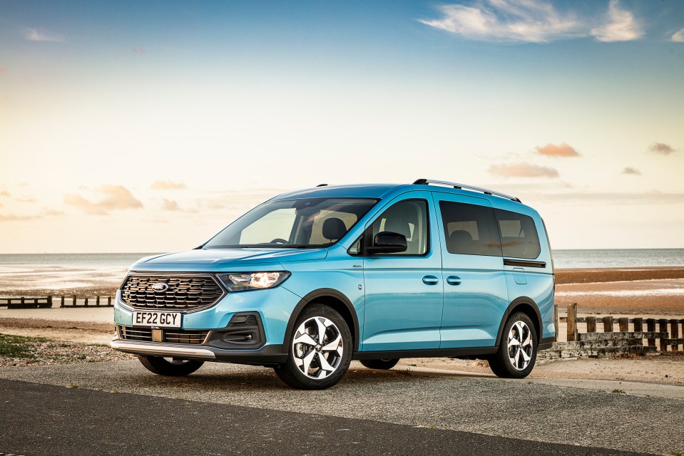 Light blue Ford Tourneo Connect parked by the beach.