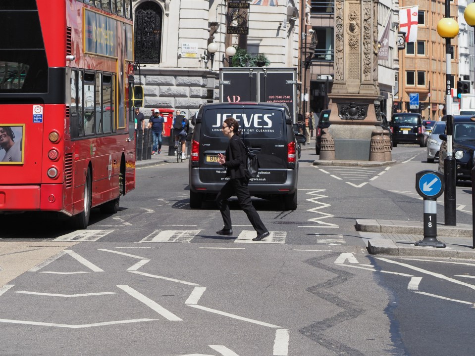 Person crossing a street in London.