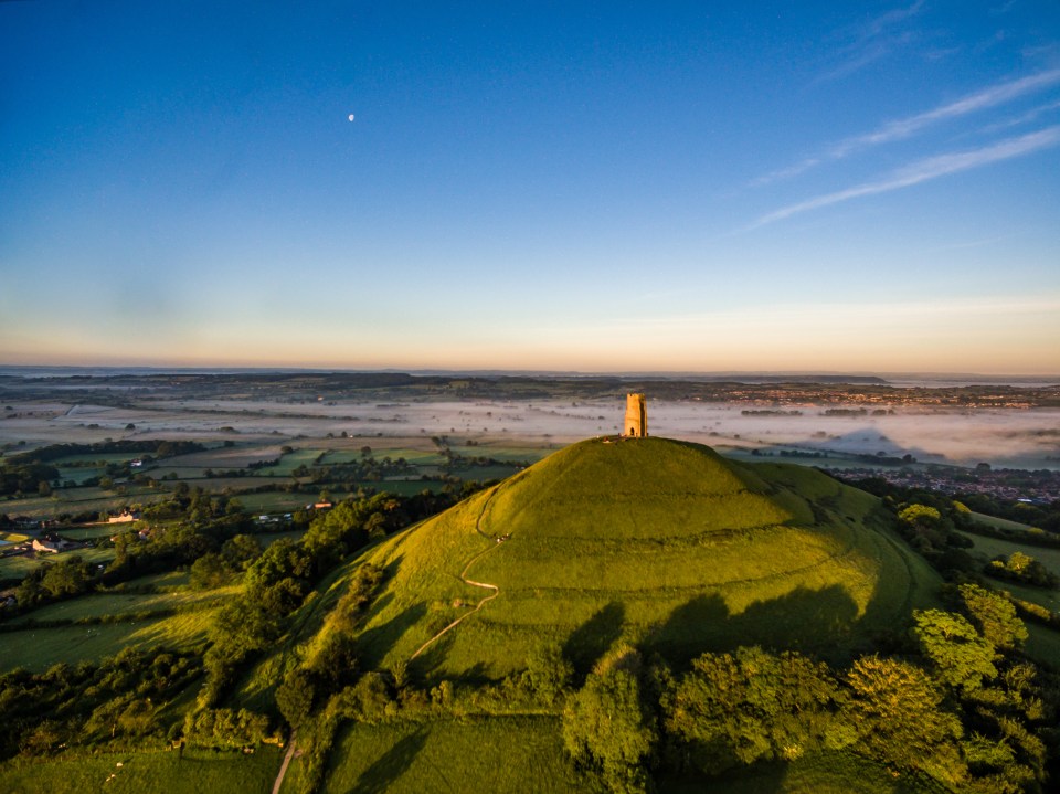 Aerial view of Glastonbury Tor at sunrise.