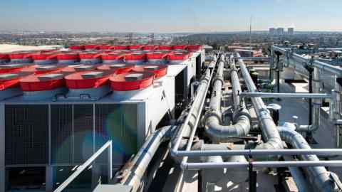 The rooftop of a data centre in Johannesburg, showing multiple large cooling units with fan covers and extensive piping infrastructure